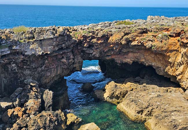 Boca do Inferno sea cliff in Cascais, a dramatic rock formation with crashing Atlantic waves, part of the Lisbon Immersive Day Tour by Lux Motion.