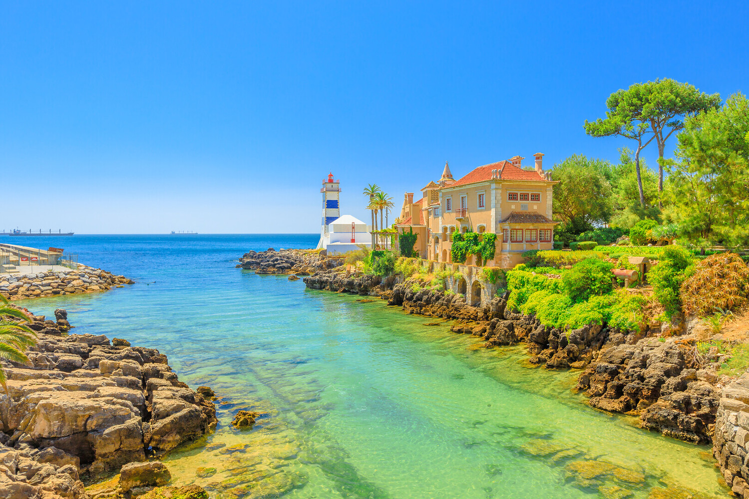 Cascais harbor with colorful fishing boats and elegant seaside atmosphere, once a royal retreat, featured in the Lisbon Immersive Day Tour by Lux Motion.