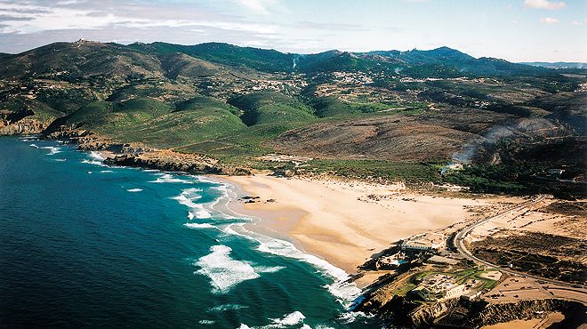 Guincho Beach within Sintra-Cascais Natural Park, famous for surfing, windsurfing and golden sand dunes, featured in the Lisbon Immersive Day Tour by Lux Motion.